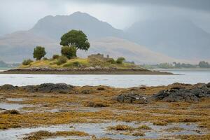 Isle with ruins, mountains and sea photo