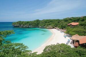 Pristine beach cove nestled within lush tropical landscape photo