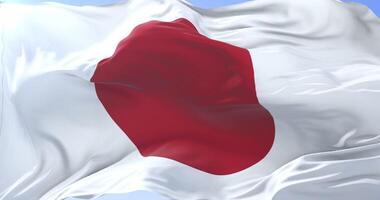 Flag of Japan waving at wind in slow in blue sky loop video