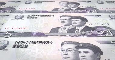 Banknotes of five wons of North Korea rolling, cash money, loop video
