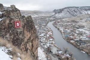 Winter landscape overlooking town and river photo
