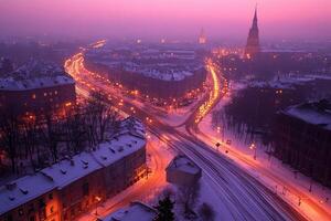Winter city at twilight. Snowy streets, illuminated buildings photo