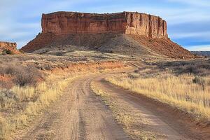 Desert road winds toward a butte photo