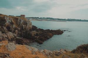 Coastal cliffs overlooking a tranquil bay photo