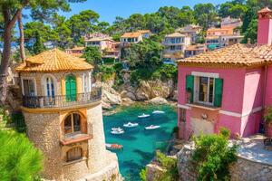 Colorful Mediterranean village nestled on a hillside overlooking a turquoise bay photo