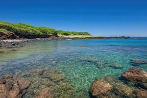 Tranquil cove with clear turquoise water photo