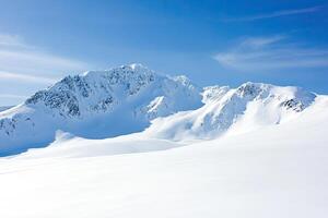 Snowy mountain peaks under a vibrant sky photo