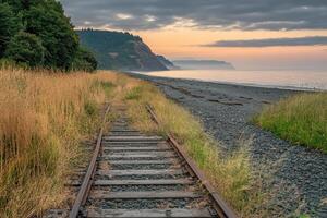 Abandoned railway track leads to a beach at dawn photo