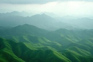 Misty mountain range, lush green hills photo