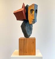 Abstract sculpted head, layered forms in contrasting colors on a wooden base photo