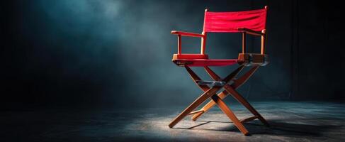 The iconic red director's chair illuminated in a dramatic cinematic setting. photo