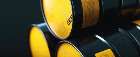 The stack of yellow and black industrial barrels on a dark background. photo