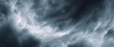 The dark and swirling clouds creating a dramatic sky atmosphere. photo