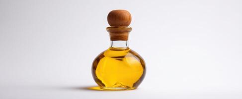 The elegant glass bottle of golden olive oil with wooden stopper. photo