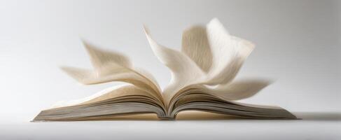 The book with pages fluttering in the air creating a dynamic motion effect. photo