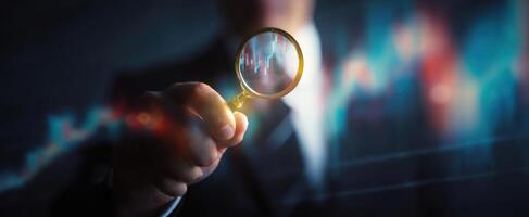 The magnifying glass revealing financial data trends in a business environment. photo