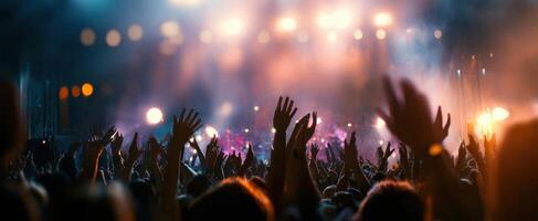 The energetic crowd enjoying a spectacular live music performance at night. photo