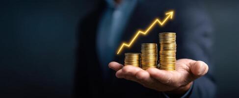 The hand displaying rising coins representing financial growth and success. photo