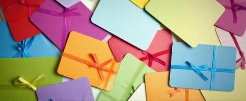 The vibrant collection of colorful gift cards with beautiful ribbons. photo