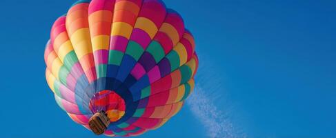 The colorful hot air balloon soaring in the clear blue sky. photo