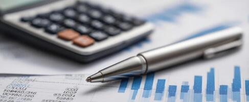 Pen and calculator on financial documents photo