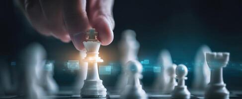 The hand moving the king in a strategic game of chess in a digital setting. photo