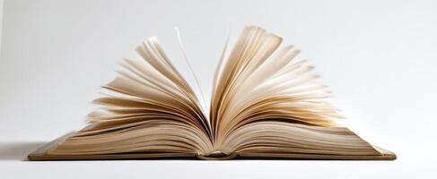 The open book with fluttering pages capturing the essence of reading adventure. photo