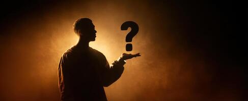 The silhouette of a person pondering life's mysterious questions against a glowing background. photo