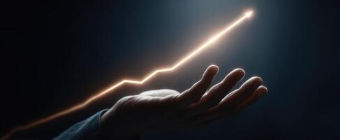 The hand illustrating upward growth trend in a dark environment. photo