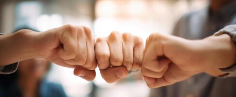 The collaborative spirit showcased through a joyful fist bump among friends. photo