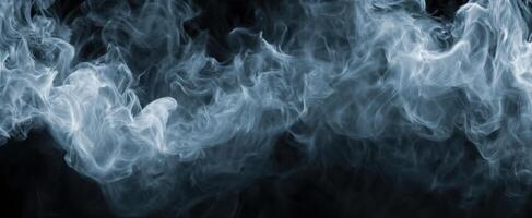 The swirling patterns of ethereal smoke against a black background. photo