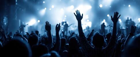 The enthusiastic crowd enjoying a vibrant live music concert under colorful lights photo
