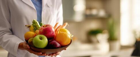 The vibrant bowl of fresh fruits held by a health professional. photo
