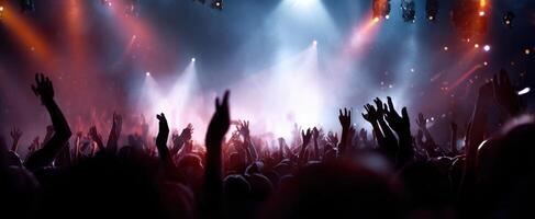 The energetic crowd raised hands at a vibrant concert performance. photo