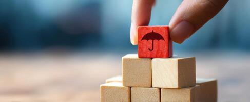 The colorful umbrella block being placed atop a stack of wooden toys. photo