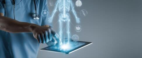 The doctor using a touchscreen tablet to analyze 3D human anatomy hologram. photo