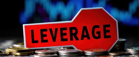 The Leverage Concept Highlighted in a Financial Context with Coins and Background Chart photo
