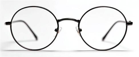 The stylish black round glasses with clear lenses on a white background. photo