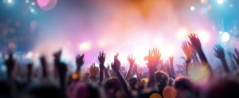 The vibrant crowd enjoying a breathtaking concert atmosphere with raised hands. photo