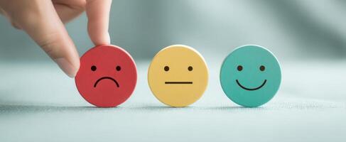 The hand selecting emotional response among color-coded expression icons photo