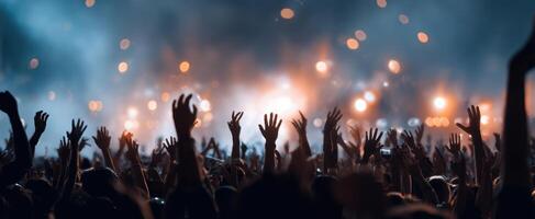 The crowd of enthusiastic hands raised during a live music concert. photo