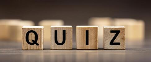 The wooden letter blocks spell out the word 'quiz' creatively and engagingly. photo