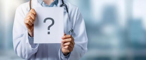 The Doctor Holding a Question Mark Sign in a Medical Setting photo