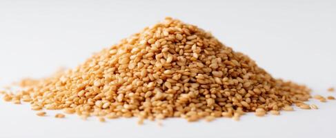 The pile of golden sesame seeds showcasing natural culinary potential. photo