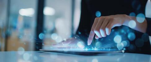 The tablet interface illuminated by a finger's touch in a digital workspace. photo