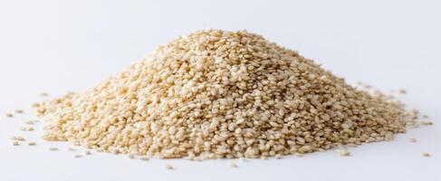 The pile of wholesome sesame seeds on a clean white background. photo