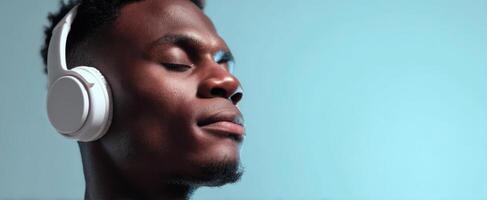 The young man enjoying music with closed eyes and headphones on. photo