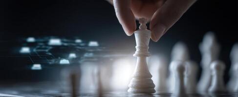 The hand moving the king piece in a digital chess game setting. photo