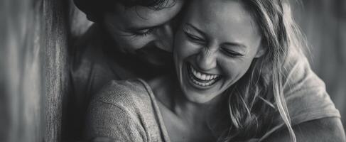 The joyful couple sharing laughter in a candid moment of intimacy. photo