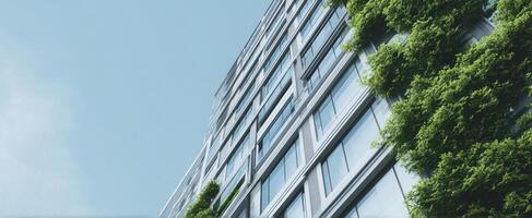 The modern building showcasing green design and contemporary architecture under a clear blue sky. photo